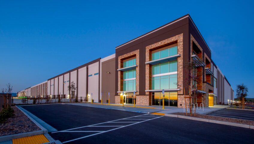A warehouse and an asphalt parking lot