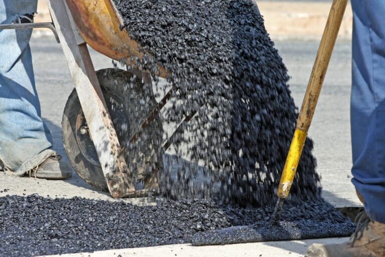Workers pouring asphalt